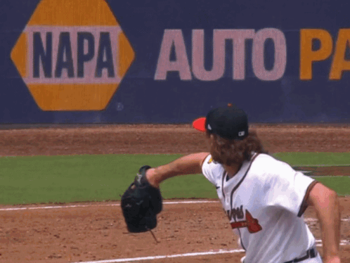 A Baseball Pitcher Throws A Ball In Front Of A Napa Auto Sign GIF
