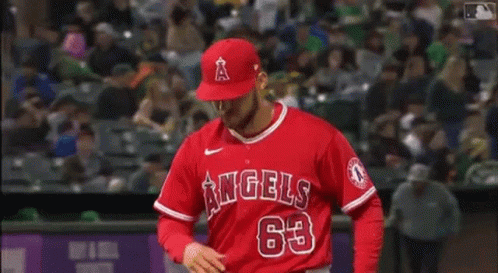 A Baseball Player For The Angels Is Standing On The Field . GIF