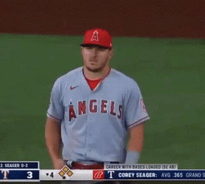 A Baseball Player For The Angels Is Standing On The Field With His Hands On His Hips GIF