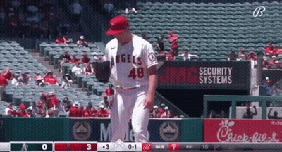A Baseball Player For The Angels Stands In Front Of A Chick-Fil-A Sign GIF