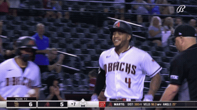 A Baseball Player For The Arizona Bricks Is Smiling And Talking To A Referee GIF