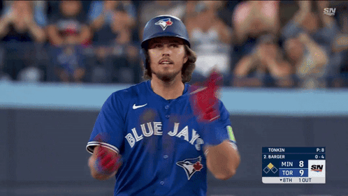 A Baseball Player For The Blue Jays Holds His Glove Up GIF