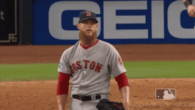 A Baseball Player For The Boston Red Sox Stands In Front Of A Geico Sign GIF