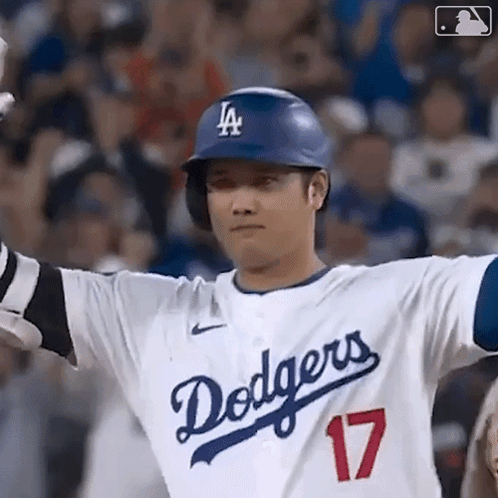 A Baseball Player For The Dodgers Is Wearing A Helmet And Gloves . GIF