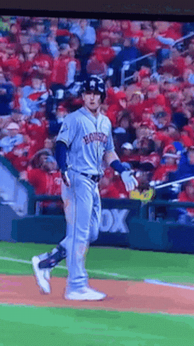 A Baseball Player For The Houston Astros Is Running Towards Home Plate GIF