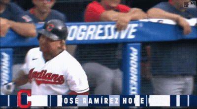 A Baseball Player For The Indians Is Standing In Front Of A Progressive Banner GIF
