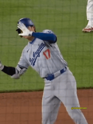 A Baseball Player For The Los Angeles Dodgers Is Standing On A Field GIF