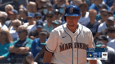 A Baseball Player For The Mariners Stands In Front Of A Crowd Of People GIF
