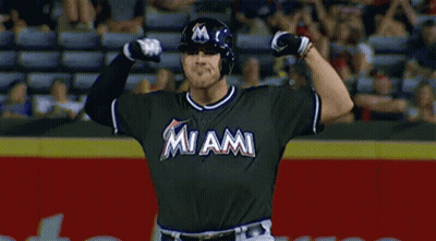 A Baseball Player For The Miami Marlins Is Flexing His Muscles GIF