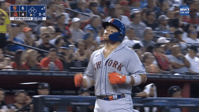 A Baseball Player For The New York Mets Is Running Towards The Fence GIF
