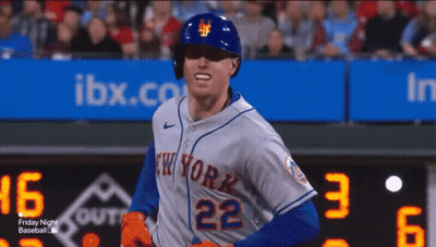 A Baseball Player For The New York Mets Is Standing In Front Of The Scoreboard GIF