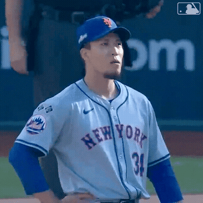 A Baseball Player For The New York Mets Stands On The Field With His Hands On His Hips GIF