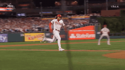 A Baseball Player For The Phillies Is Running Towards Home Plate GIF