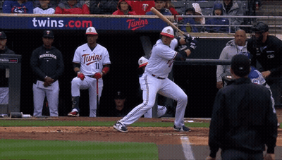 A Baseball Player For The Twins Is About To Swing At A Pitch GIF