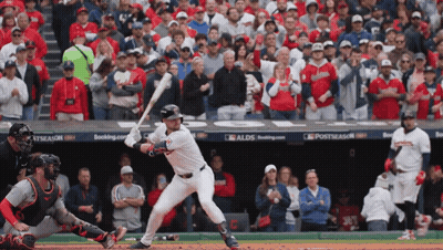 A Baseball Player Getting Ready To Hit A Ball In Front Of A Crowd With A Sign That Says Postseason On It GIF