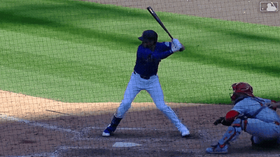 A Baseball Player Getting Ready To Hit The Ball With A Mlb Logo In The Background GIF