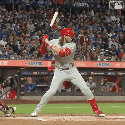 A Baseball Player Getting Ready To Swing His Bat In Front Of A Crowd That Says Amazing GIF
