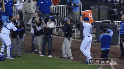 A Baseball Player Holding A Gatorade Bucket In His Hand GIF