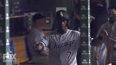 A Baseball Player In A Chicago Uniform Is Standing In The Dugout GIF