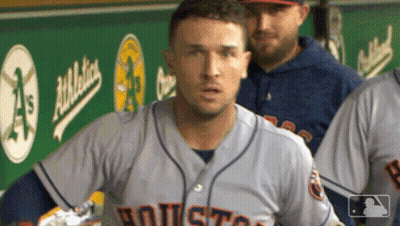 A Baseball Player In A Houston Jersey Stands In The Dugout GIF