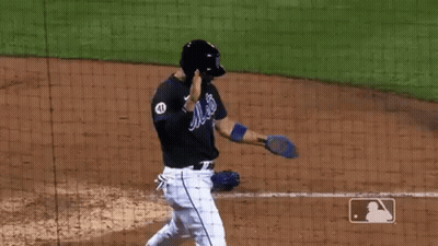 A Baseball Player In A Mets Uniform Is Standing On The Field . GIF