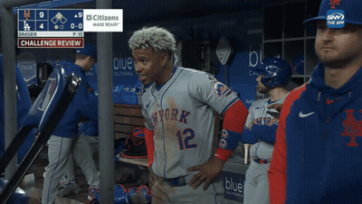 A Baseball Player In A New York Jersey Stands In The Dugout GIF