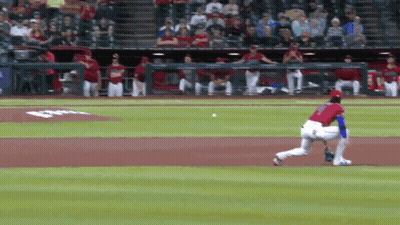 A Baseball Player In A Red And Blue Uniform Runs Towards The Base GIF