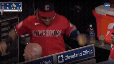 a baseball player in a red guardians jersey