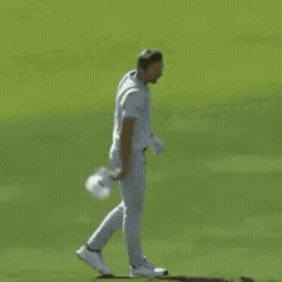 A Baseball Player In A White Uniform Is Standing On A Field . GIF
