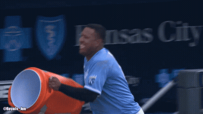 A Baseball Player In Front Of A Kansas City Advertisement GIF