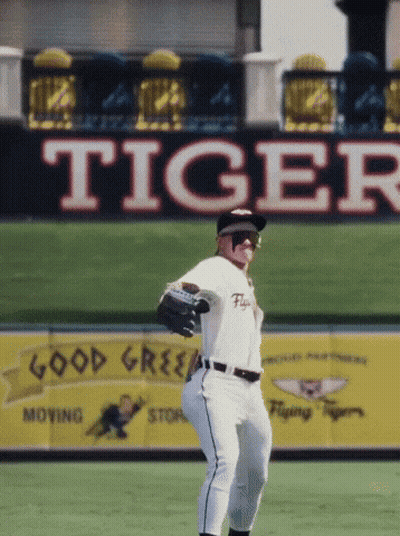 A Baseball Player In Front Of A Large Tiger Sign GIF