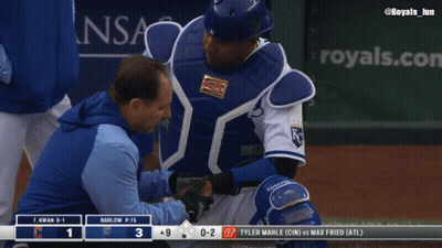 A Baseball Player Is Being Examined By A Doctor On The Field GIF