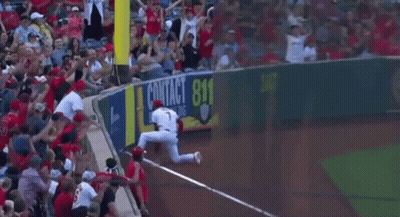 A Baseball Player Is Getting Ready To Catch A Ball While A Crowd Watches . GIF
