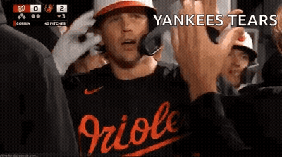 A Baseball Player Is Giving A High Five To A Fan While Wearing A Yankees Shirt . GIF