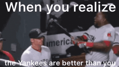 A Baseball Player Is Holding A Bat And Talking To Another Player In The Dugout . GIF