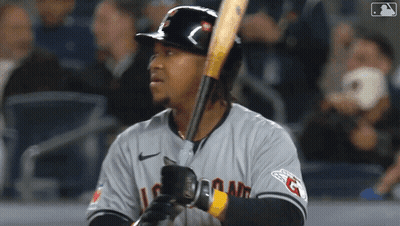 A Baseball Player Is Holding A Bat And Wearing A Jersey That Says Indians GIF