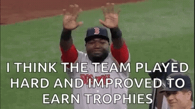 A Baseball Player Is Raising His Hands In The Air While Wearing A Red Sox Uniform . GIF