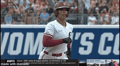 A Baseball Player Is Running In Front Of A Sign That Says ' Sec Votes 8 League Games ' GIF