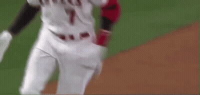 A Baseball Player Is Running On A Baseball Field With A Bat In His Hand . GIF