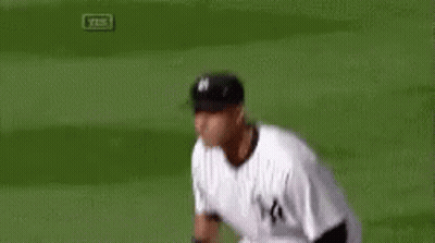 A Baseball Player Is Running On A Field While Wearing A Ny Yankees Uniform . GIF