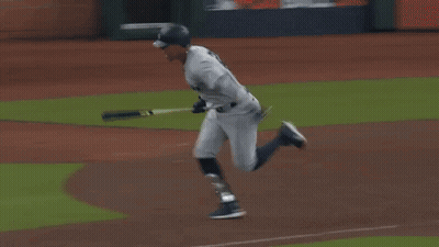 A Baseball Player Is Running On A Field With A Sign That Says ' A ' On It GIF