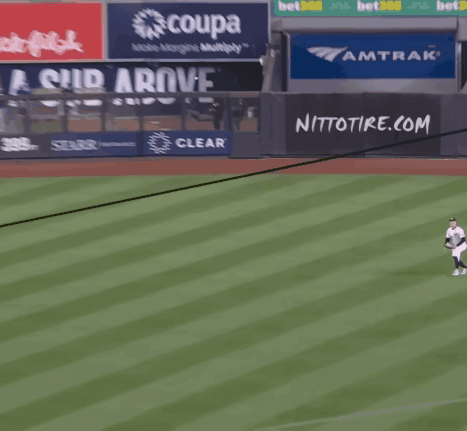 A Baseball Player Is Running On The Field In Front Of A Sign For Nitto Tire.com GIF
