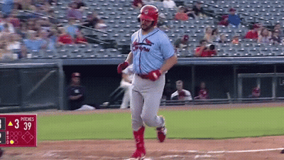 A Baseball Player Is Running To First Base During A Baseball Game . GIF