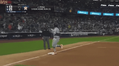 A Baseball Player Is Running To The Base During A Game . GIF
