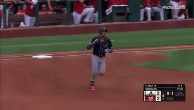 A Baseball Player Is Running Towards The Base During A Game GIF