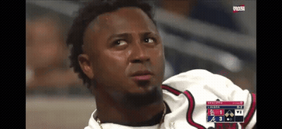 A Baseball Player Is Sitting In The Dugout Watching A Game GIF