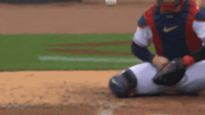 A Baseball Player Is Sitting On The Ground Waiting For The Ball To Be Thrown To Him . GIF