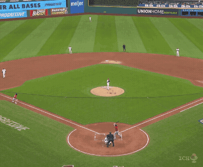 A Baseball Player Is Sliding Into Home Plate While A Referee Looks On GIF