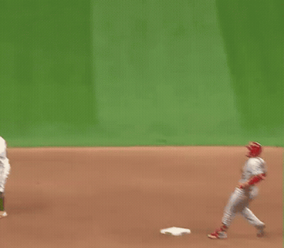 A Baseball Player Is Standing On A Base On A Field . GIF