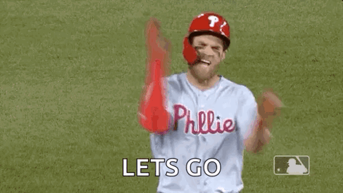 A Baseball Player Is Standing On A Field With His Arms In The Air And Says `` Let 'S Go '' . GIF